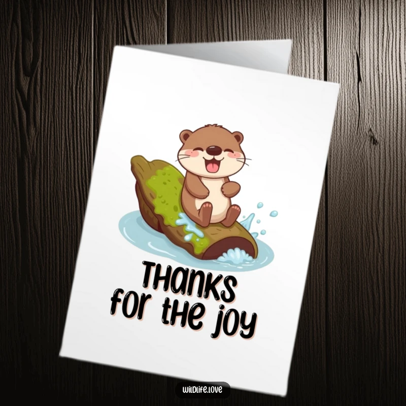 Free Printable Thank You Card: Giggling otter sliding down a mossy log with a joyful splash, a fun way to express thanks.